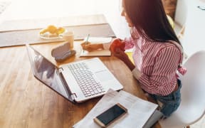 Young woman at home planning family budget and finances
