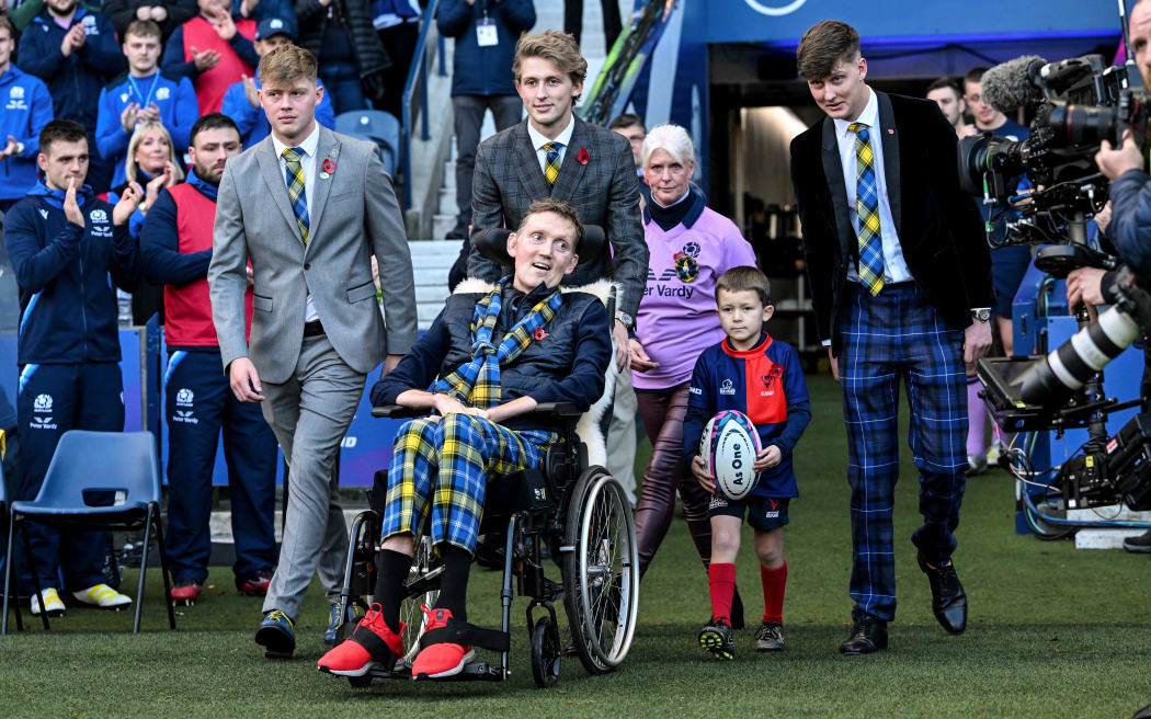 Doddie Weir accompanied by family members onto Murrayfield ahead of a Test between Scotland and the All Blacks.