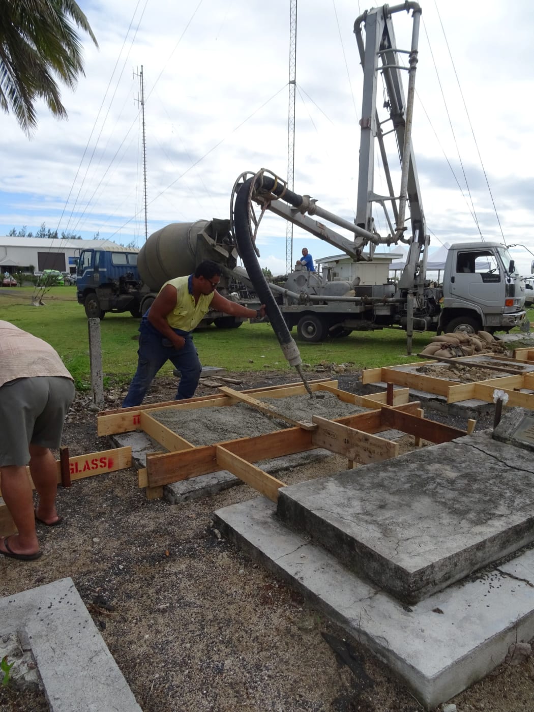 Concrete is poured to restore the graves at Nikao Cemetery on Rarotonga, Cook Islands.