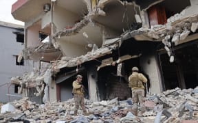 Lebanese soldiers inspect a residential area that was devastated by the war between Israel and Hezbollah, in the southern coastal town of Naqura, on the border with Israel on January 22, 2025.