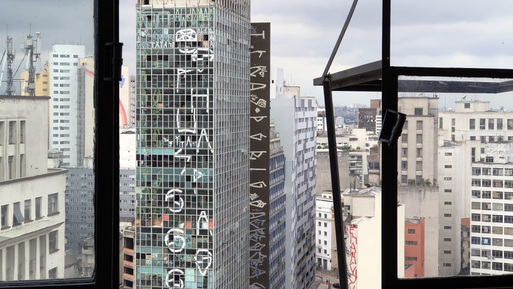 Still from the documentary Skin of Glass showing the graffti covered modernist building Pele de Vidro in São Paulo, Brazil