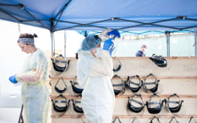 Medical workers putting on PPEs at the beginning of their shift at the emergency field hospital run in Central Park on April 08, 2020 in New York, United States.