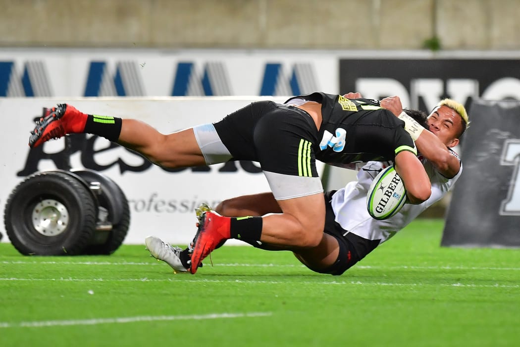 Hurricanes Ben Lam (L) is tackled by Sunwolves' Hosea Saumaki during the Hurricanes vs Sunwolves Super Rugby match at the Westpac Stadium in Wellington on Friday the 27th of April 2018. Copyright Photo by Marty Melville / www.Photosport.nz