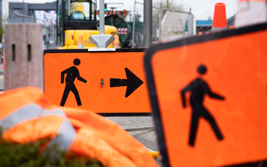 Signs alongside roadworks tell pedestrians where to go
