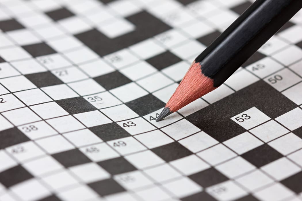 Crossword puzzle and pencil