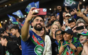 Shaun Johnson of the Warriors poses for selfies with fans after the NRL Preliminary Final match between Brisbane Broncos and New Zealand Warriors at Suncorp Stadium