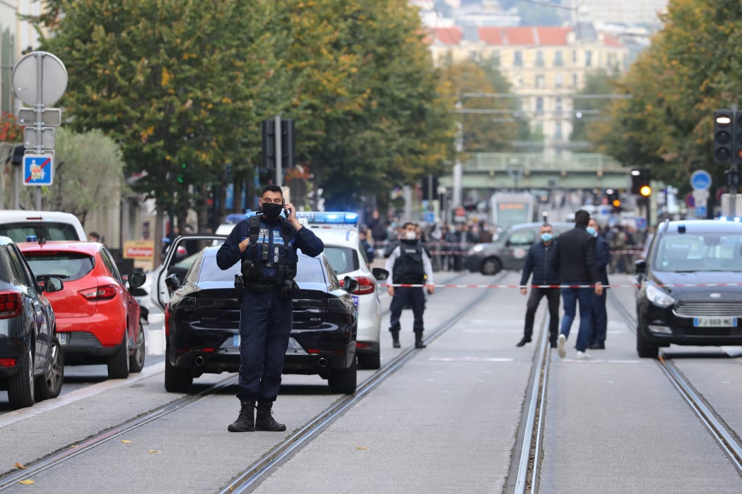 French policemen stand guard a street after a knife attack in Nice.