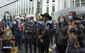 Former members of Nxivm, Linda Chung (2R), Nicki Clyne (L) and Michelle Hatchette (C) speak outside the court after Keith Raniere was sentenced to 120 years in prison.