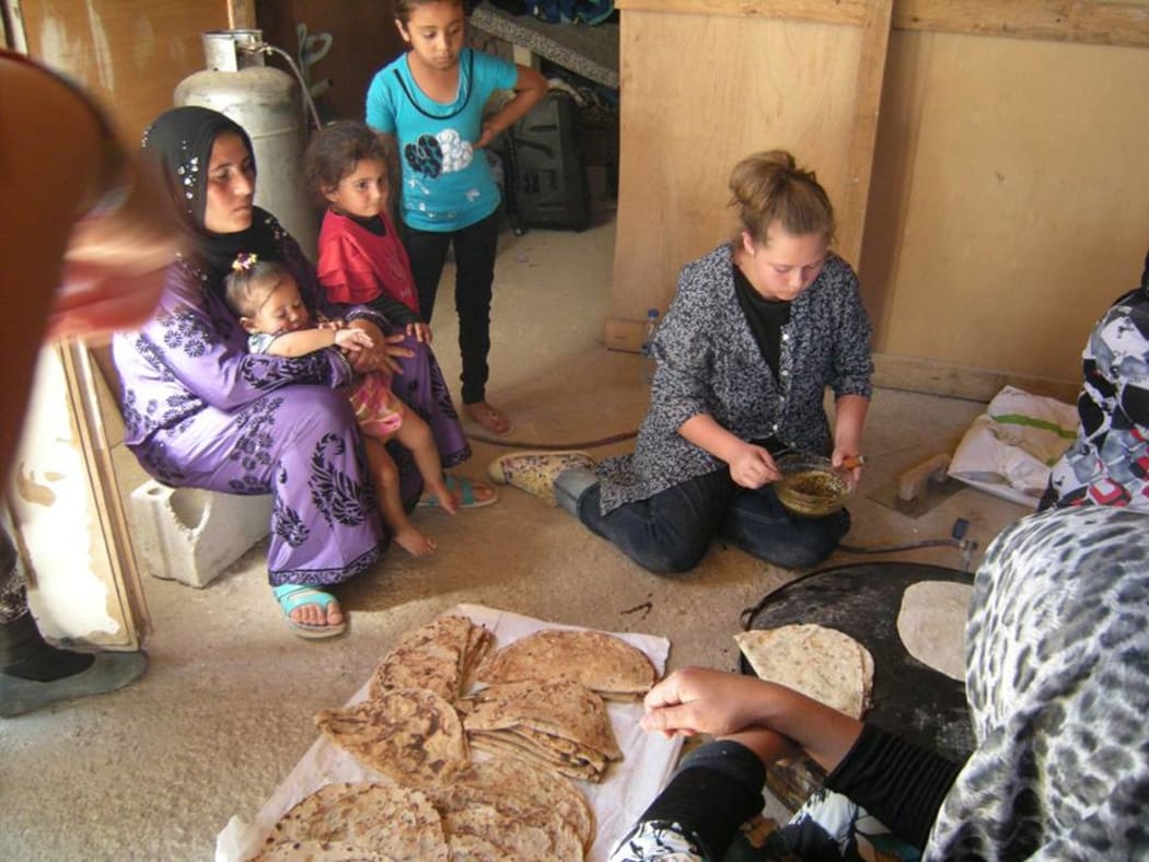 Sophia Brown (seated on floor) with Syrian refugees in Lebanon