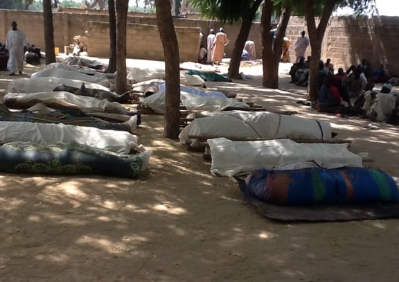 Bodies laid out for burial in the village of Konduga.