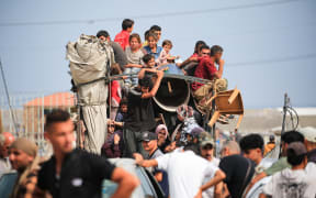 Palestinians flee the area of Tal al-Sultan in Rafah with their belongings following renewed Israeli strikes in the city in the southern Gaza Strip on May 28, 2024, amid the ongoing conflict between Israel and the Palestinian Hamas militant group. (Photo by Eyad BABA / AFP)
