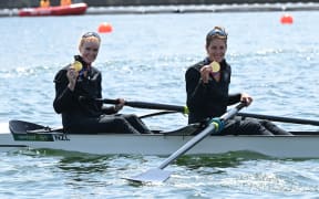 Gold medallists Grace Prendergast and Kerri Gowler pose in their boat following their women's pair final win.