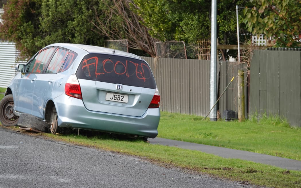 A flooded-out car remains on the side of the road in Wairoa.