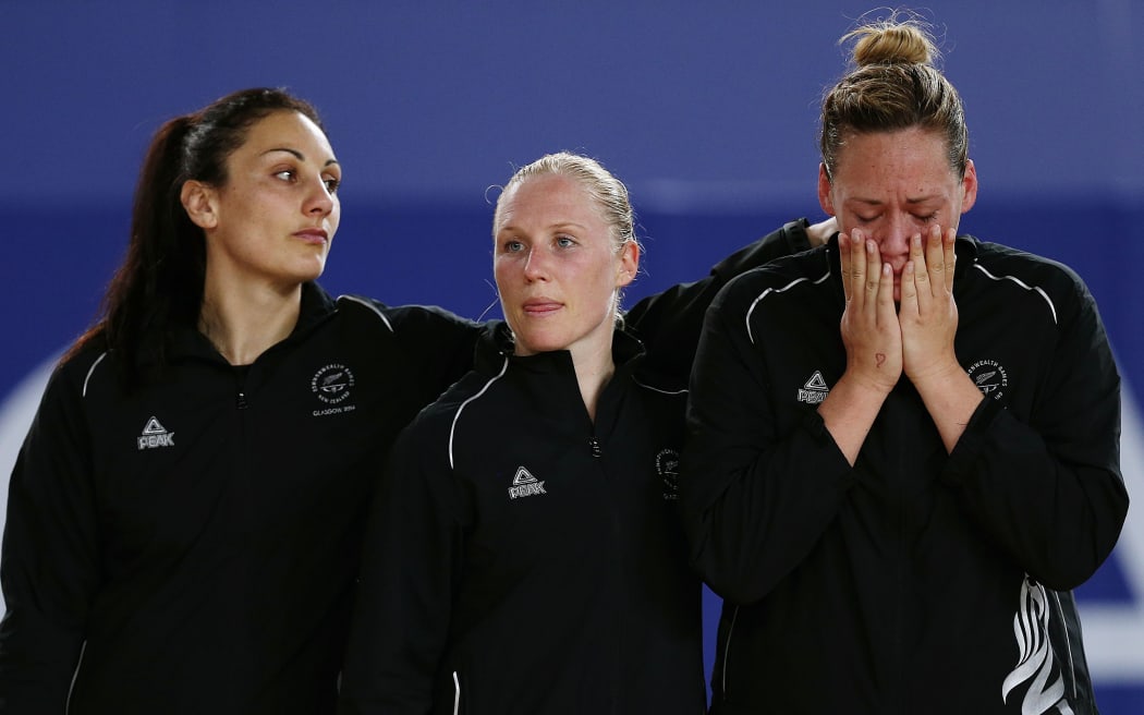 The Silver Ferns Joline Henry (L), Laura Langman and Cathrine Latu react to their Commonwealth Games loss to Australia.
