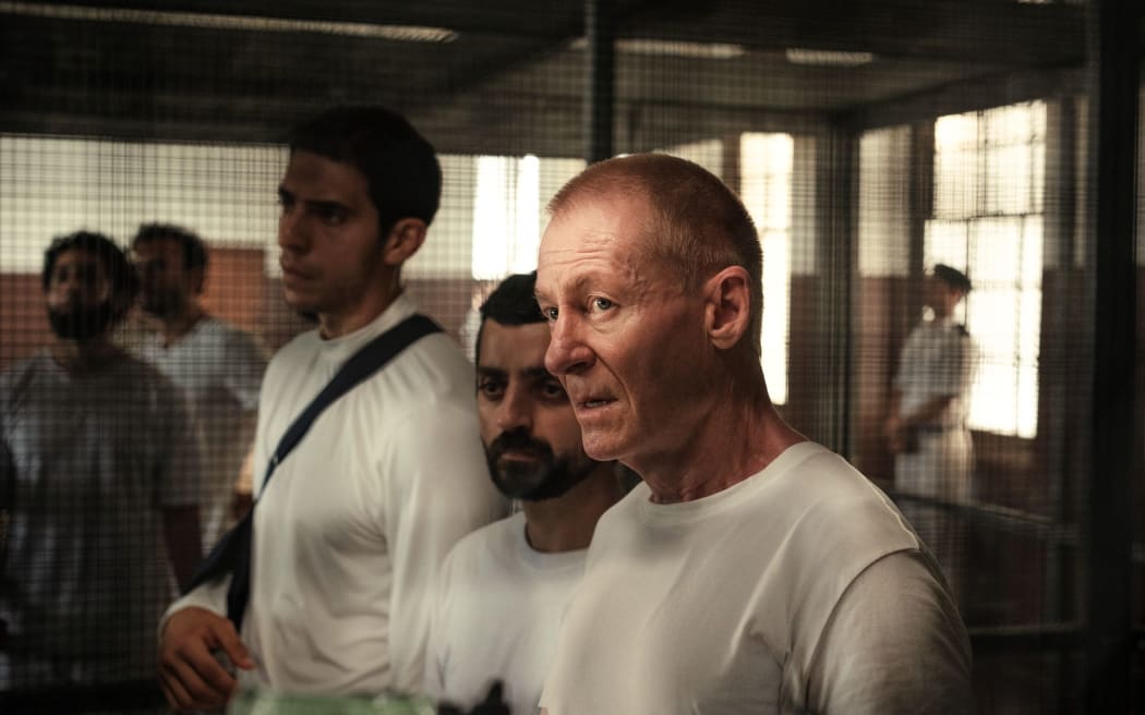 Actor Richard Roxburgh as jailed journalist Peter Greste in The Correspondent, alongside Al Jazeera colleagues Mohammed Fahmy and Baher Mohammed.