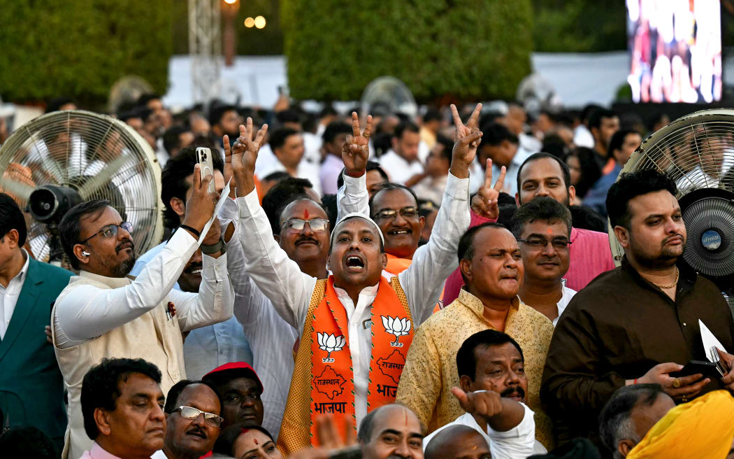 Supporters of Bharatiya Janata Party (BJP) cheer before the start of the oath-taking ceremony of India's Prime Minister Narendra Modi and Council of Ministers at the presidential palace Rashtrapati Bhavan in New Delhi on June 9, 2024.