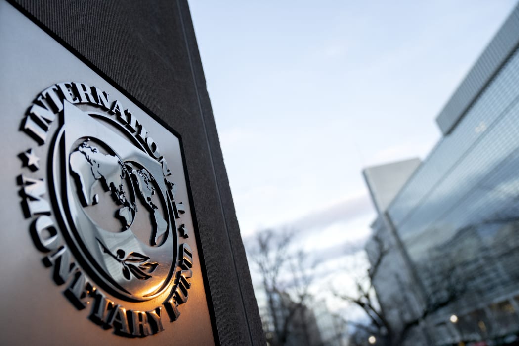 The seal for the International Monetary Fund is seen near the World Bank headquarters, right, in Washington, DC on 10 January, 2022.
