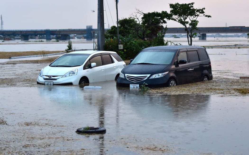 Submerged vehicles in floodwaters after an embankment of the Kinugawa river collapsed.