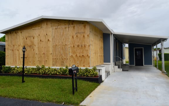 A boarded up house is seen in Deerfield Beach, Florida on September 2, 2019. -