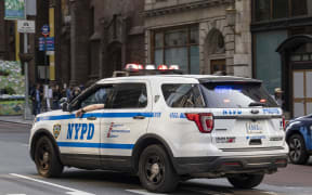 NYPD car as seen on 5th avenue near Trump Tower. Parked and moving New York City Police Department vehicles on the road are spotted moving in the traffic or parked along the street of the Fifth Ave with the NYPD logo on the side of the car and the inscription Courtesy Professionalism Respect CPR. New York City, United States of America on May 2023 (Photo by Nicolas Economou/NurPhoto) (Photo by Nicolas Economou / NurPhoto / NurPhoto via AFP)