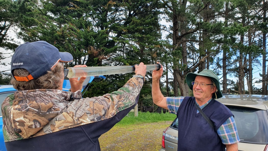 Christine Finnigan and Terry Parminter measure water clarity of the Nguturoa Stream