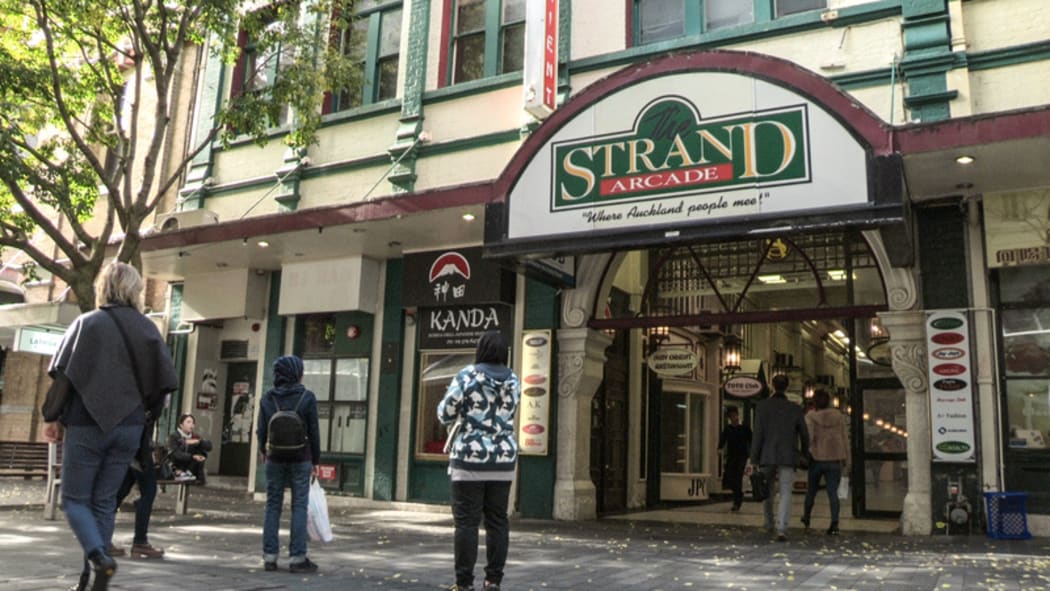 Outside facade with pedestrians walking past The Strand in Auckland City