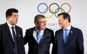 International Olympic Committee President Thomas Bach (C) poses with North Korea's Sports Minister and Olympic Committee president Kim Il Guk (L) and South Korean Minister of Culture, Sports and Tourism Do Jong-hwan.