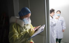 Nurse Sun Chun reads medical records at a hospital in Wuhan, yesterday.