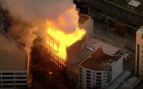 A building is on fire in downtown Sydney.