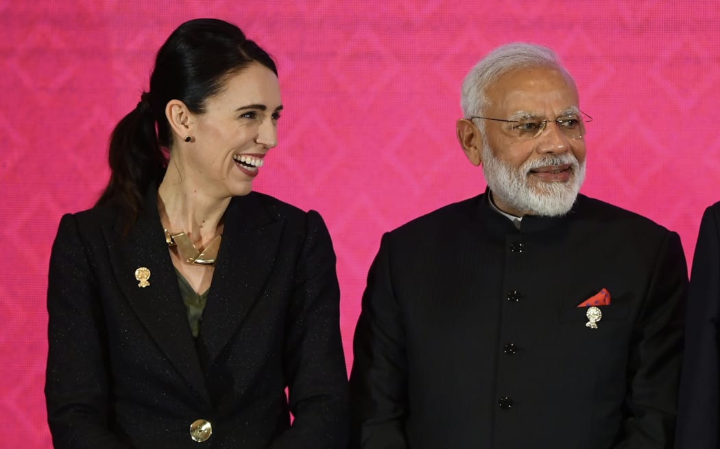 New Zealand's Prime Minister Jacinda Ardern stands next to India's Prime Minister Narendra Modi at the RCEP summit in Bangkok in 2019.