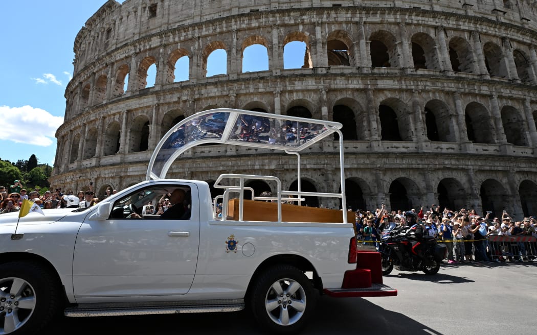 The coffin of Pope Francis is seen in front of the Colosseum as it is transported from St Peter's Basilica to Santa Maria Maggiore Basilica, after a funeral mass in Rome on 26 April, 2025.