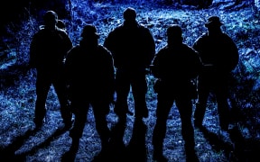 Shadowy figures with weapons.