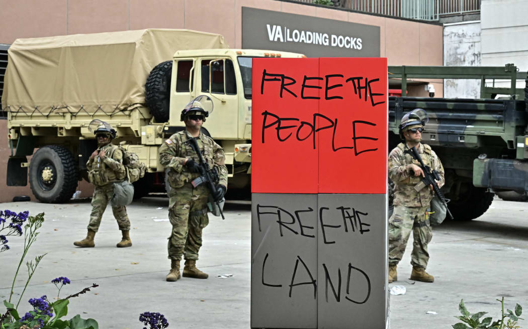 Members of the National Guard stand guard outside the Metropolitan Detention Center, MDC in downtown Los Angeles, California on June 8, 2025. US President Donald Trump deployed 2,000 troops on June 7 to handle escalating protests against immigration enforcement raids in the Los Angeles area, a move the state's governor termed "purposefully inflammatory." Federal agents clashed with angry crowds in a Los Angeles suburb as protests stretched into a second night Saturday, shooting flash-bang grenades and shutting part of a freeway amid raids on undocumented migrants, reports said. (Photo by Frederic J. Brown / AFP)