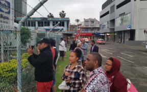 Supporters and media look on as the detainees head back inside again.