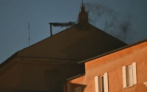 Black smoke rising from the chimney of the Sistine Chapel signalling that cardinals failed to elect a new pope in the first ballot of their conclave in the Vatican on 7 May, 2025.