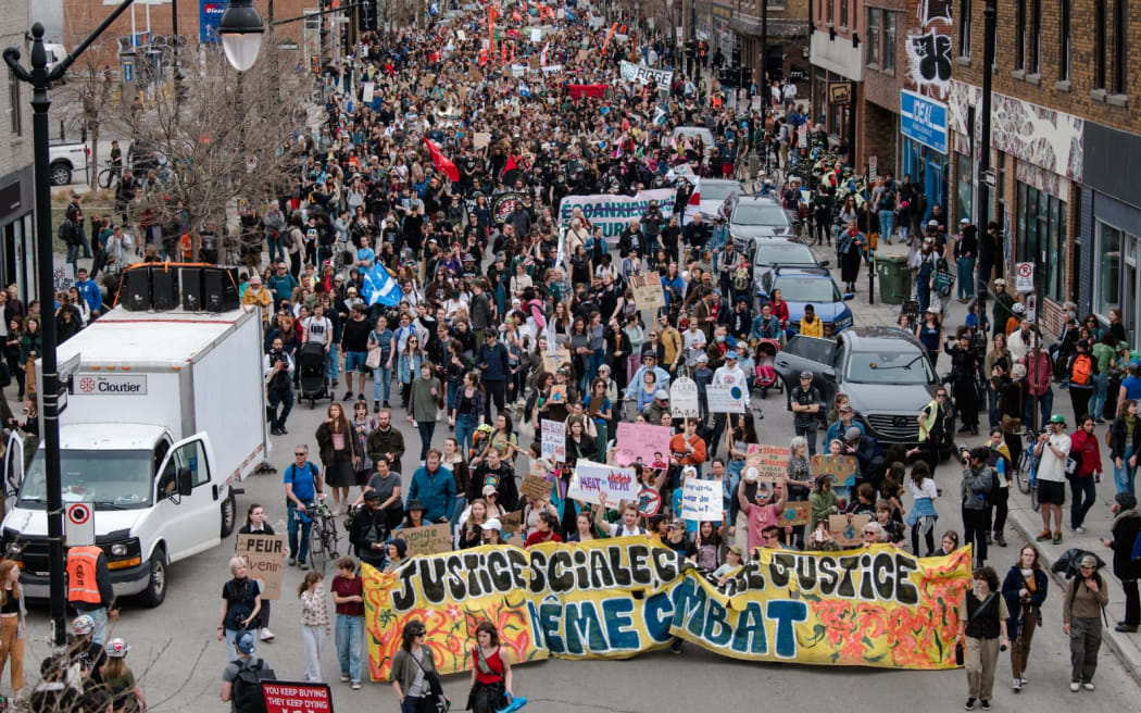 Protesters march during the Earth Day Protest on April 22, 2023, in Montreal, Canada. - Some 7000 people according to an official tally were said to have attended the march intended to raise awareness about the growing climate crisis. (Photo by ANDREJ IVANOV / AFP)