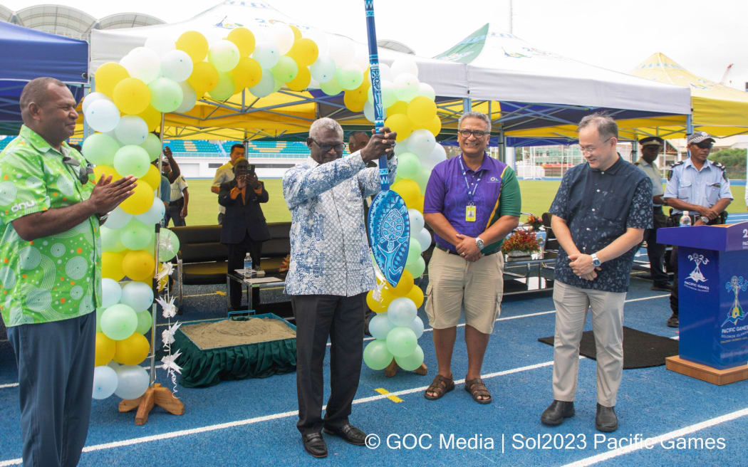 Solomon Islands Prime Minister Manasseh Sogavare with the Pacific Games baton