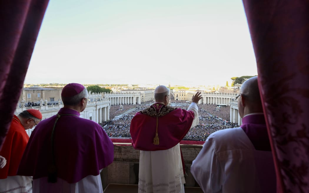 This photo taken and handout on May 7, 2025 by The Vatican Media shows Newly elected Pope Leo XIV, Robert Prevost addressing the crowd from the main central loggia balcony of the St Peter's Basilica for the first time, after the cardinals ended the conclave, in The Vatican. (Photo by Handout / VATICAN MEDIA / AFP) / RESTRICTED TO EDITORIAL USE - MANDATORY CREDIT "AFP PHOTO / VATICAN MEDIA" - NO MARKETING - NO ADVERTISING CAMPAIGNS - DISTRIBUTED AS A SERVICE TO CLIENTS