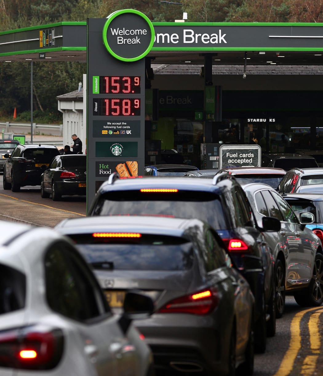 Motorists queue for petrol and diesel  at a petrol station off the M3 motorway near Fleet, west of London, on 26 September 2021.
