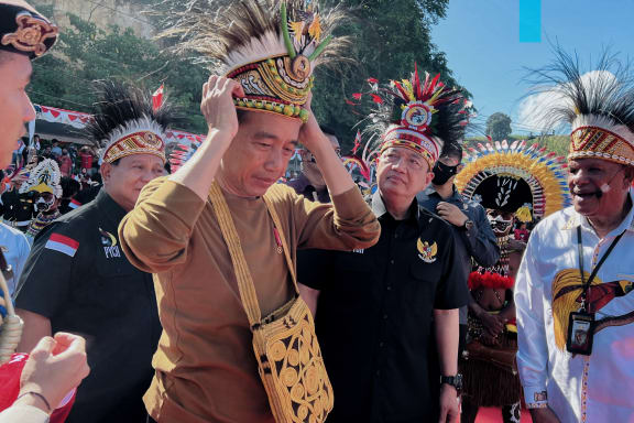 Archive photo taken in March 2023 of Indonesia's President Joko Widodo wearing a traditional Papuan headwear during a visit to the provincial capital Jayapura.