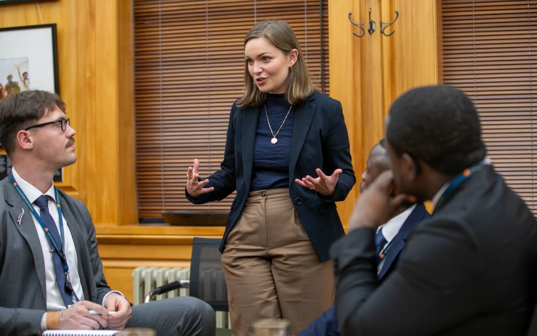 National MP Katie Nimmon offers her expertise to delegates during a committee session of the Commonwealth Youth Parliament.