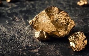 Gold nuggets on dark background