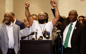 George Floyd's brother Terrence Floyd, centre, holds up his hands with family lawyer Ben Crump, right.following the verdict in the trial of former police officer Derek Chauvin in Minneapolis, Minnesota.