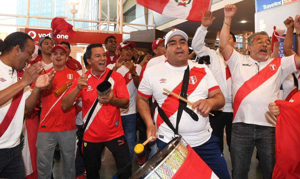 Peru football fans celebrate the arrival of their team at Auckland Airport.