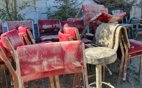 Ruined chairs outside the Tīnui pub, Wairarapa, during the clean-up post Cyclone Gabrielle