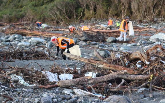Volunteers pick up rubbish where a disused Fox River landfill spilled litter on the West Coast.