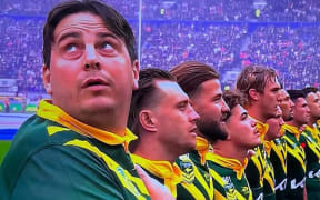 Daniel Jarvis (left) stood with the Kangaroos as the national anthems were played before kick-off. (X: Craig Wall)