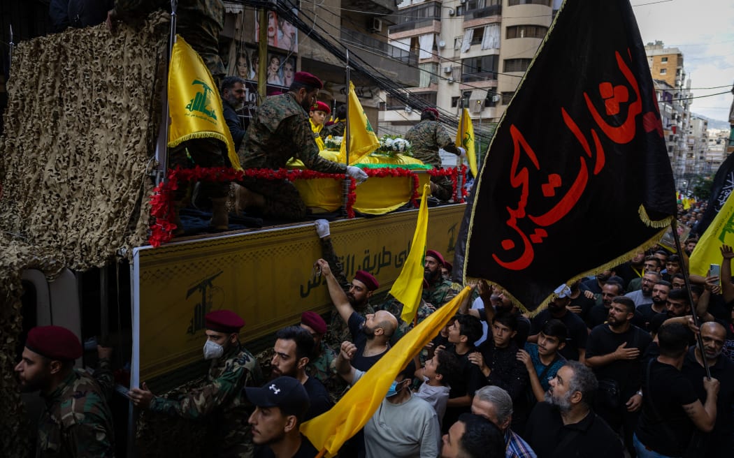 The coffins of Ibrahim Aqil, the Hezbollah Radwan Forces commander, and Mahmoud Hamad, another Hezbollah commander, both killed in an Israeli airstrike on a residential building are driven through the streets of the southern suburb of Dahiyeh in Beirut, Lebanon. (Photo by Oliver Marsden / Middle East Images / Middle East Images via AFP)