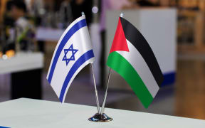 Small tabletop flags of Israel and Palestine together at some event or fair. Flags of two countries as a symbol of cooperation between states. Joint business between Palestine and Israel.