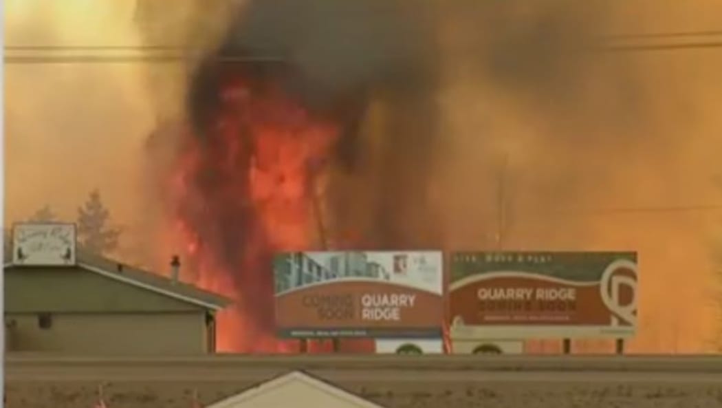 Flames close in on buildings in Fort McMurray.